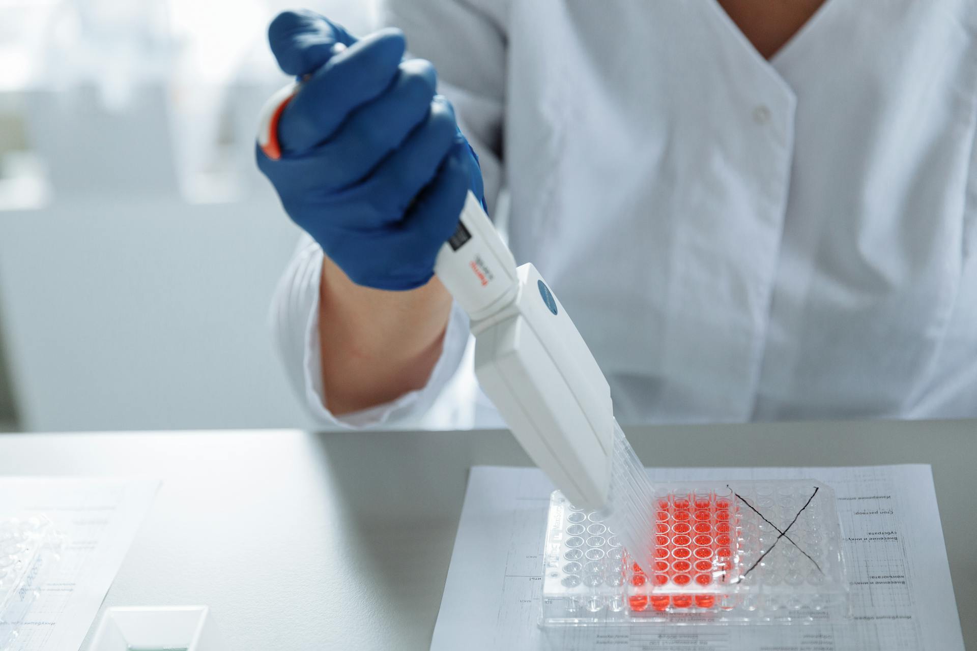 Close-up of a Lab Worker Distributing Medication into Capsules